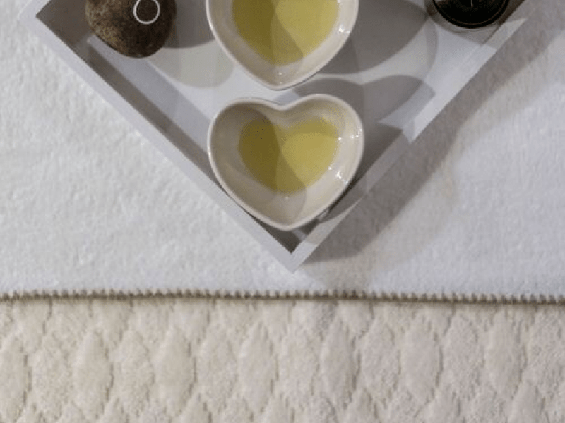 A plate with 3 heart shaped bowls containing a yellow liquid