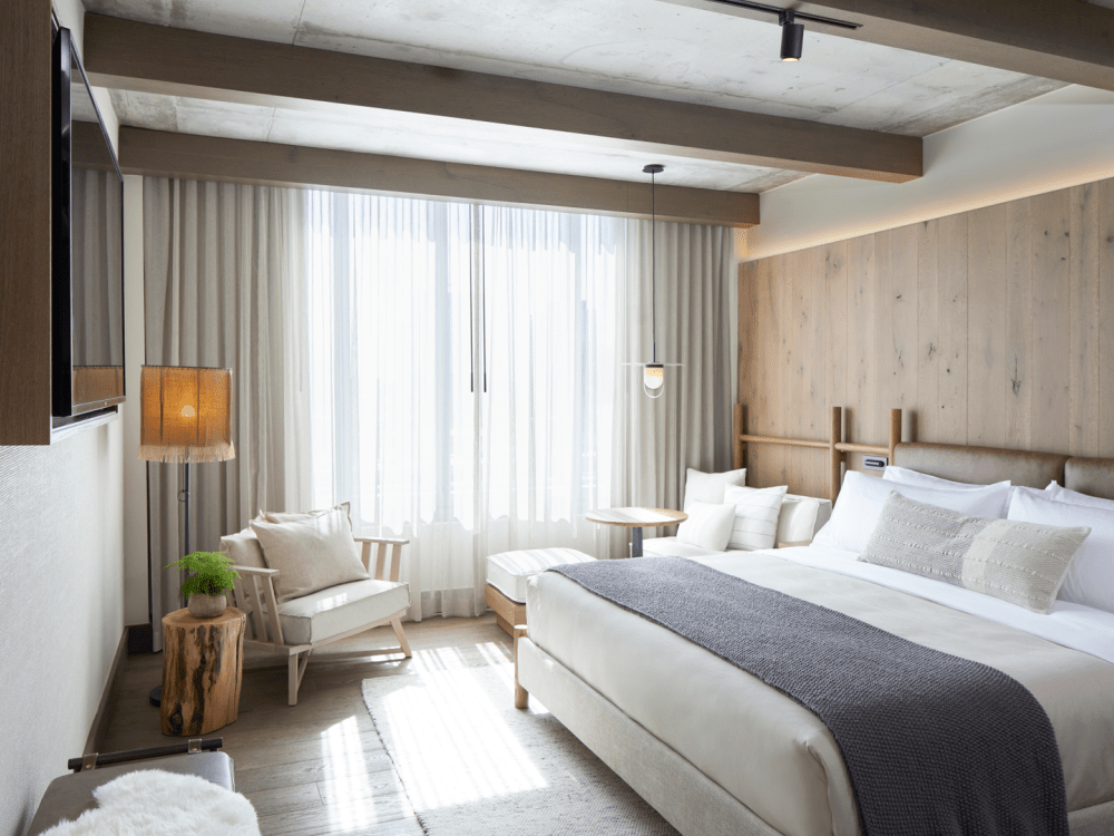 Un grande letto king size inondato di sole dalla finestra vicina