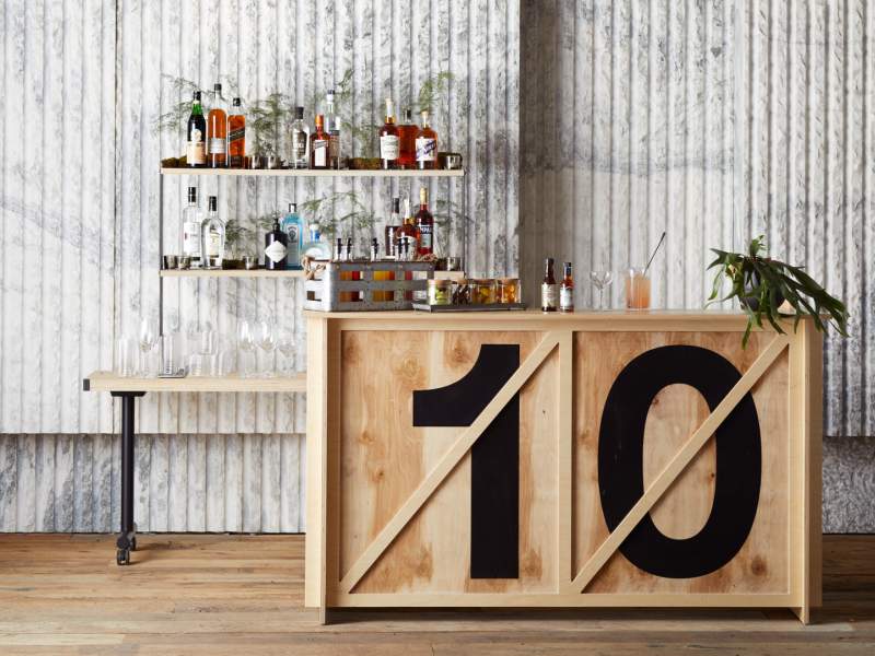 Meadow Rue satellite bar featuring a full rack of varying alcohol and spirits