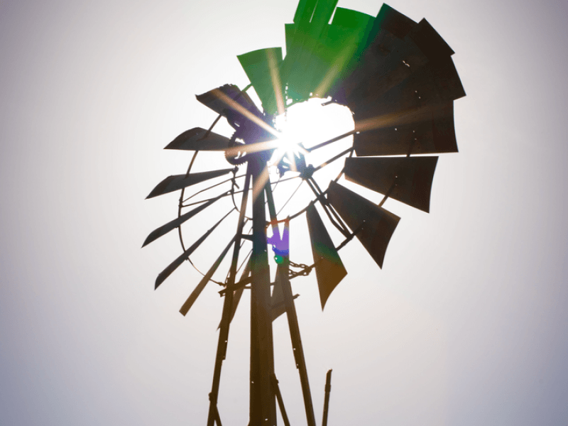 Glare of the sun through windmill spokes