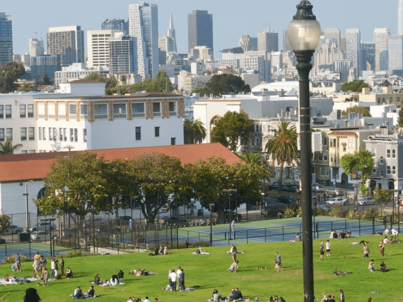 People at a public park with the skyline in the background