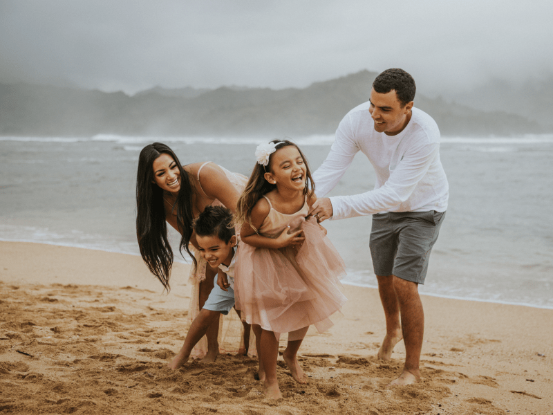 Family on beach doing a photoshoot