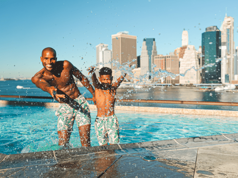 Man and son in a rooftop pool