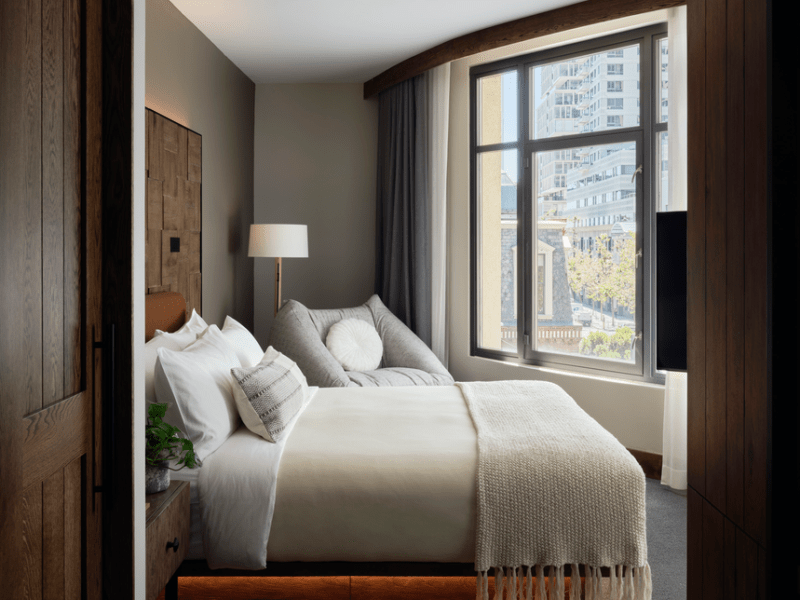 Looking into a Studio suite room with king bed overlooking views of the city