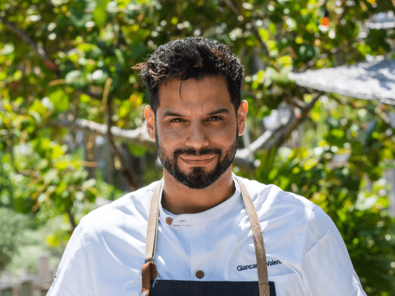 A chef holding a plate of food