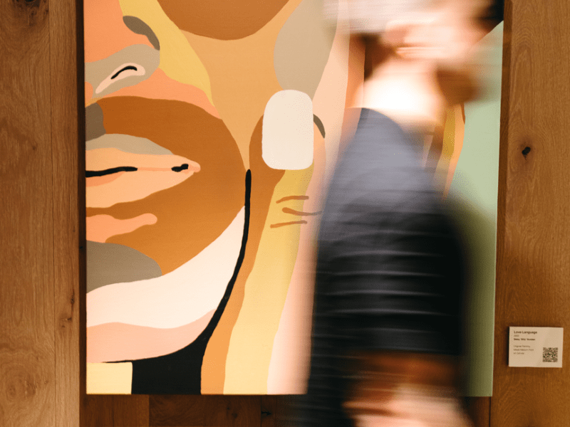 Person quickly walking by a piece of art