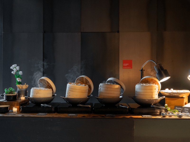 Four dishes of steaming food