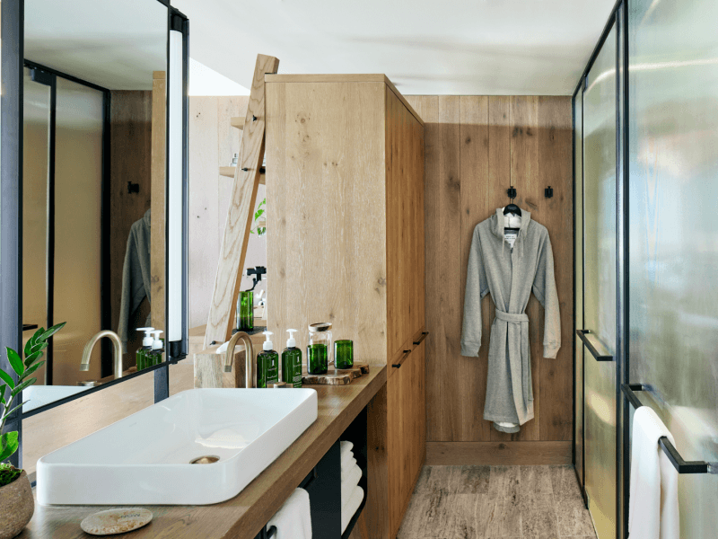 Wood paneled bathroom with housecoat hanging up