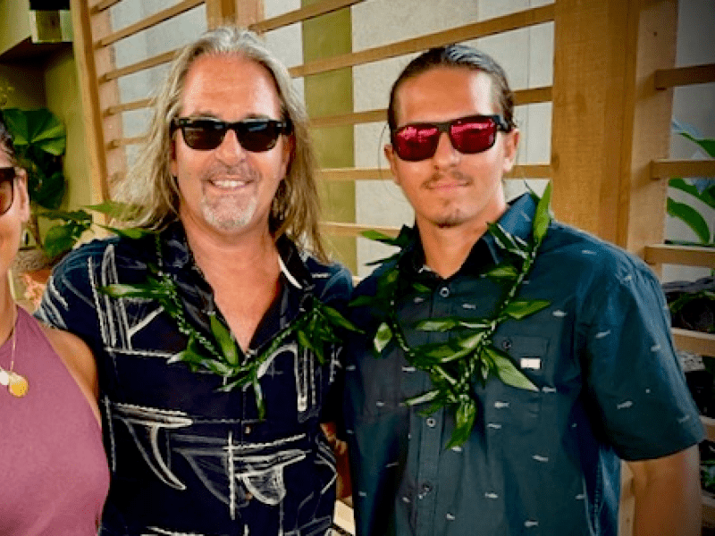 Three people with sunglasses, posing for a photo