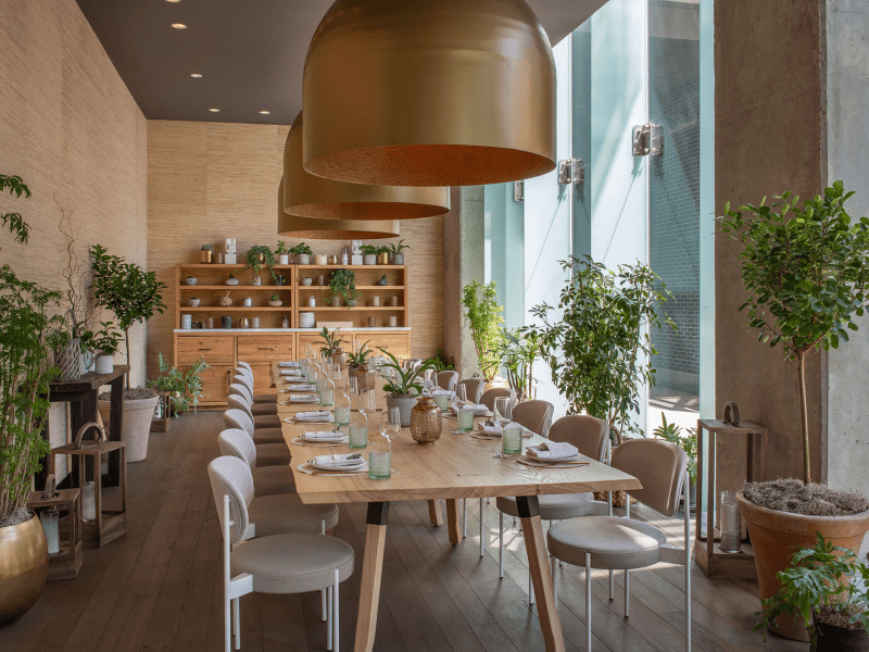 Light colored dining area with long table