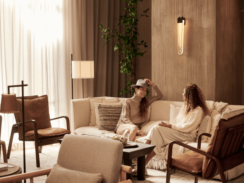 Two women sit in West Lounge