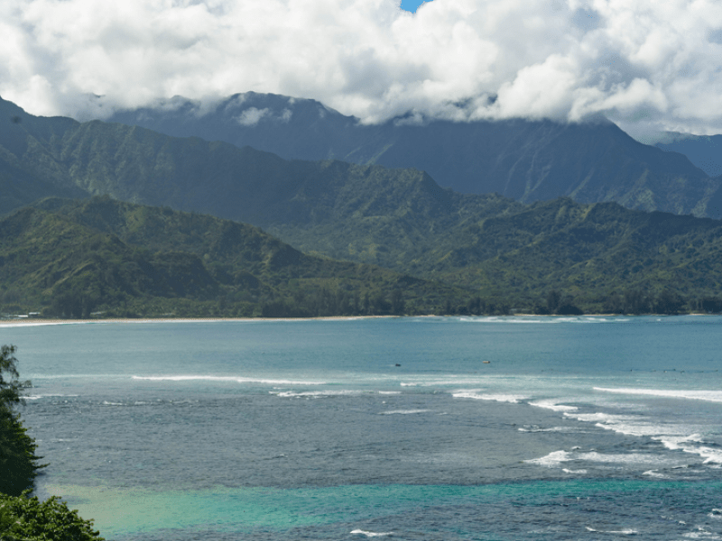 A beach with mountains in the background