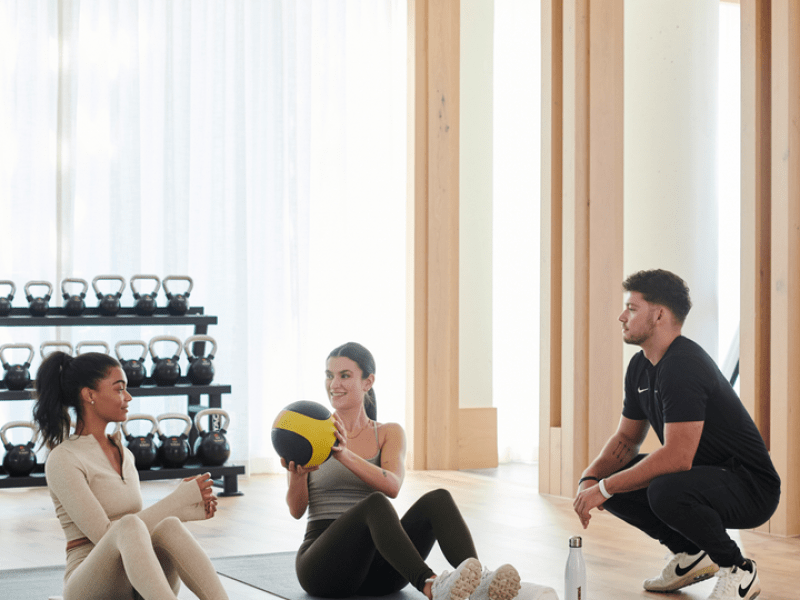 Three people working out in a gym