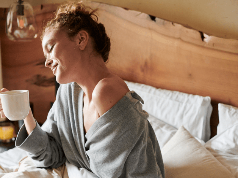 Woman eating breakfast in bed 