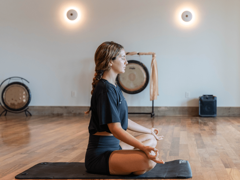 Person sitting cross-legged, meditating