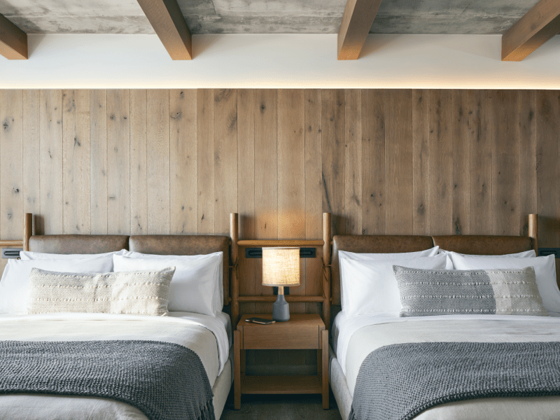 Two double beds with wooden headboards sit side by side