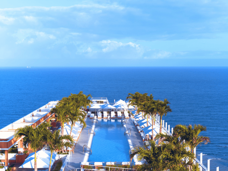 Birds eye view of a pooldeck area next to the ocean
