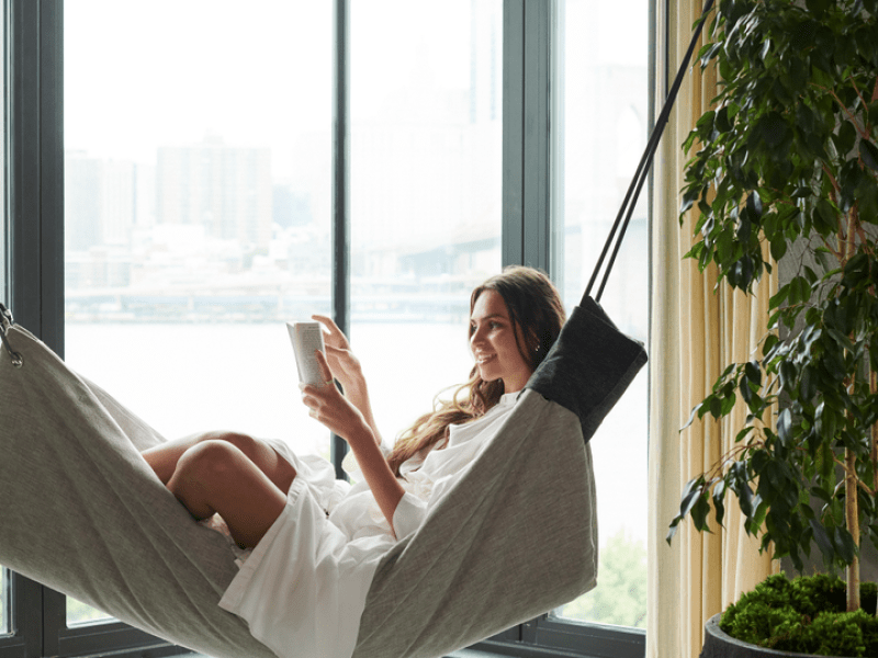 Woman reading a book in a hammock