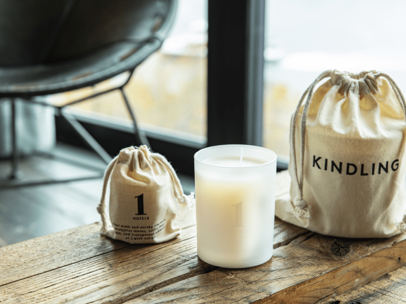 A wooden table with white candles 