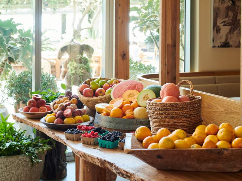 Lobby farmstand table full of fruit