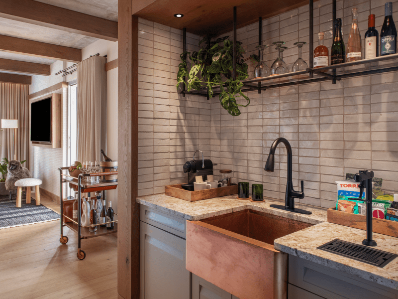 Kitchen with a grey slate back splash and copper sink