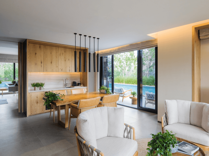 Indoor living room area with a pool outside