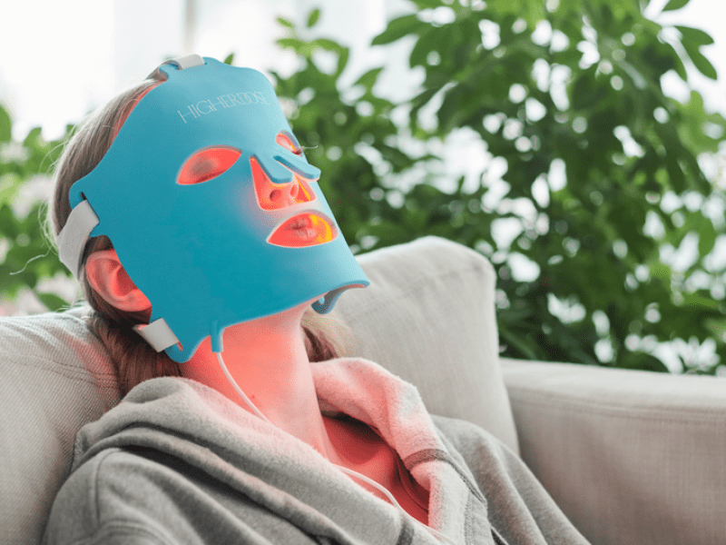 A woman at the spa getting a facial mask