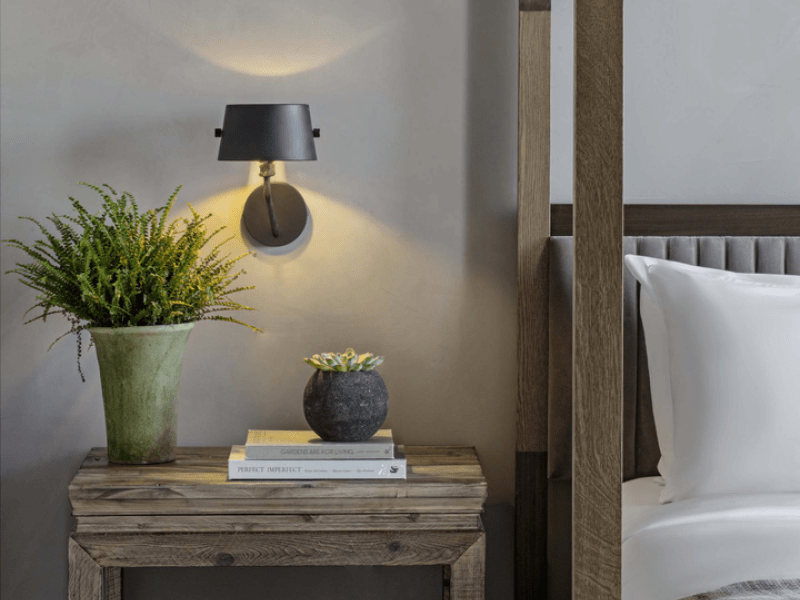 Wooden bedside table with a potted plant