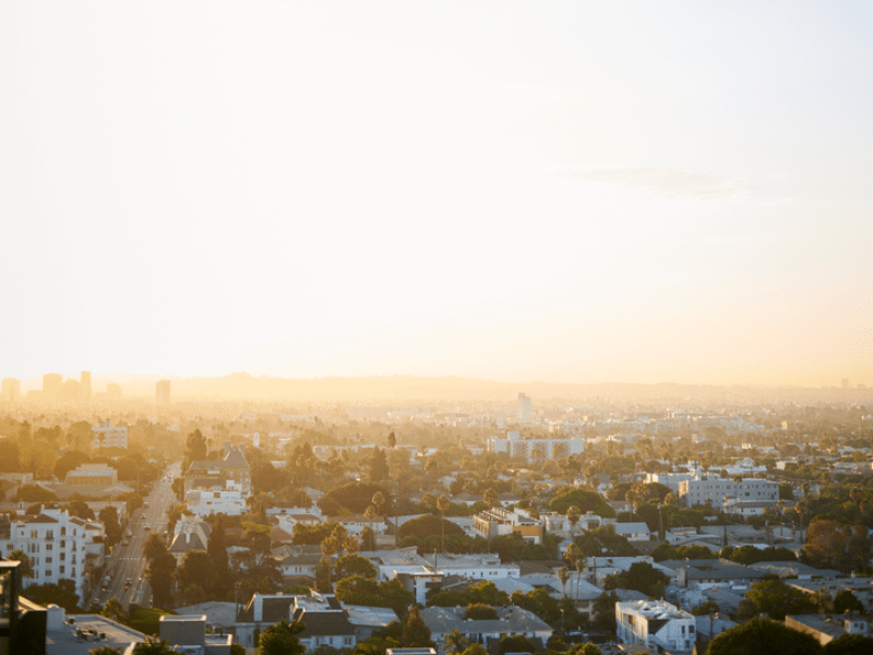 Sun and blue skies on the horizon over the cityscape