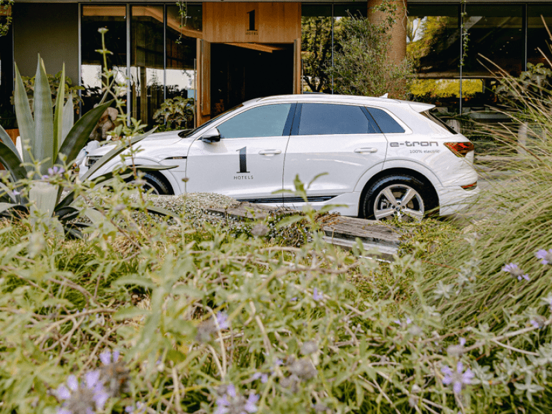 A white 1 Hotels branded SUV parked in front of 1 Hotels West Hollywood