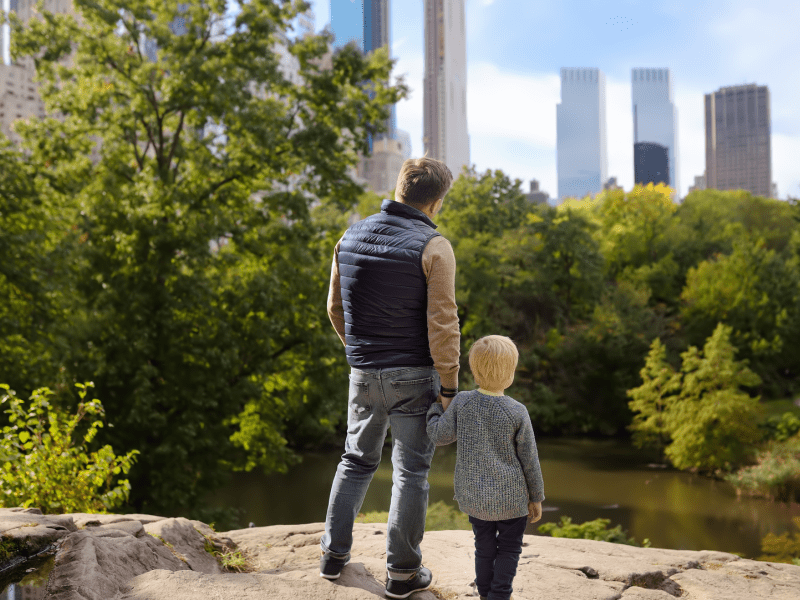Man and son looking out at Central Park 