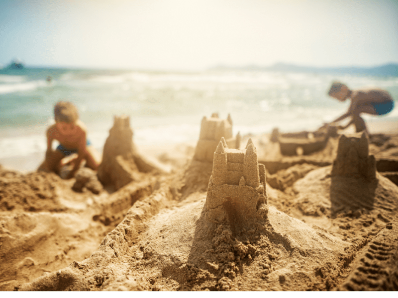 Children building a sandcastle on the beach