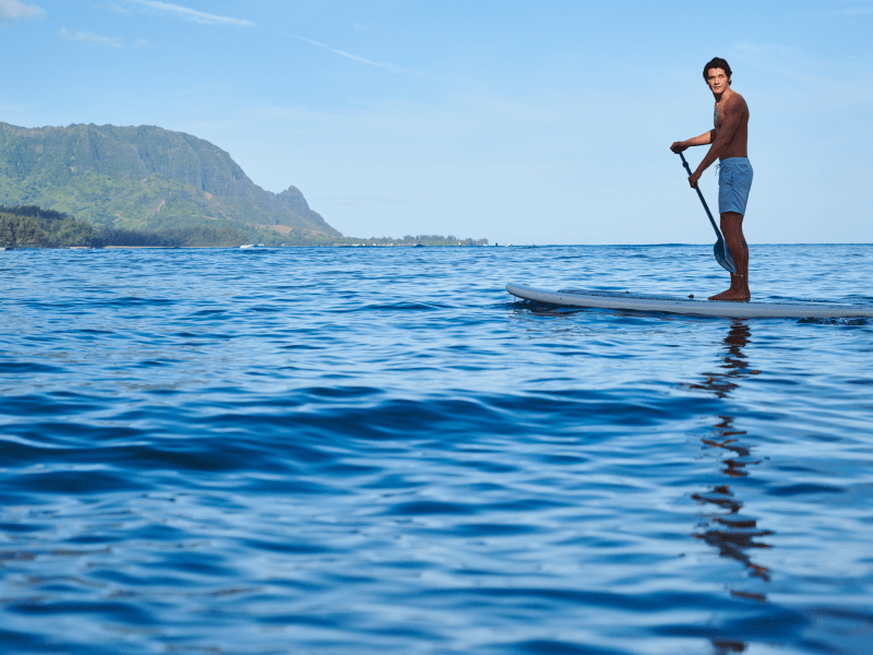 man stand up paddling