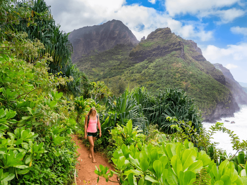 Person walking barefoot on a jungle trail