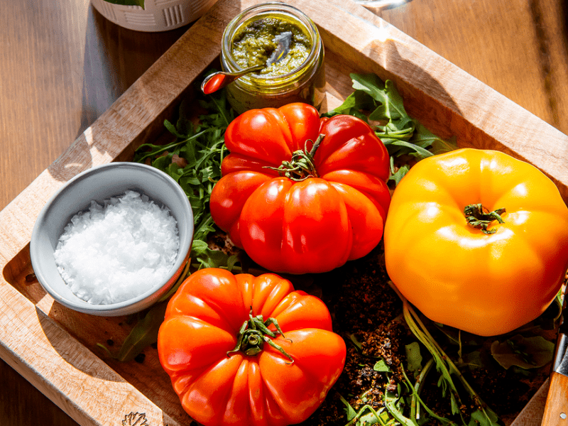 Tomatoes on a board with salt