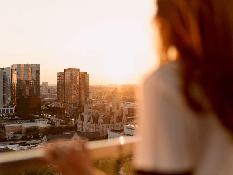 A person on the balcony overlooking the city