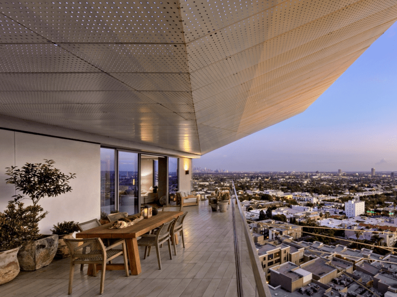 A high up balcony with a table and chairs