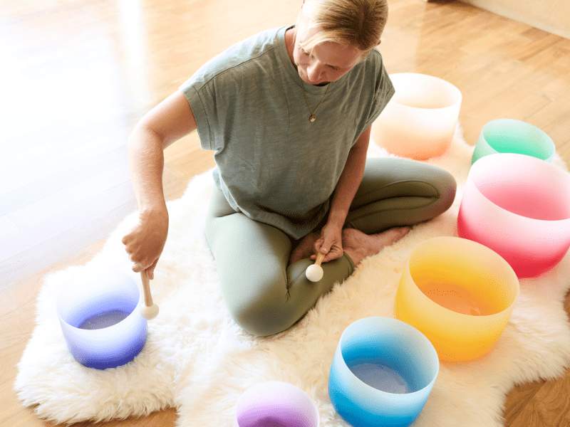 Instructor playing crystal bowls