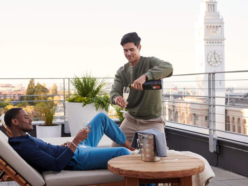 two people drinking champagne on a patio