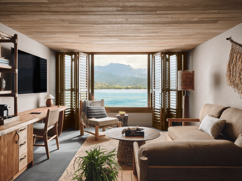 Living area with a deep sectional couch and a window looking out to the water