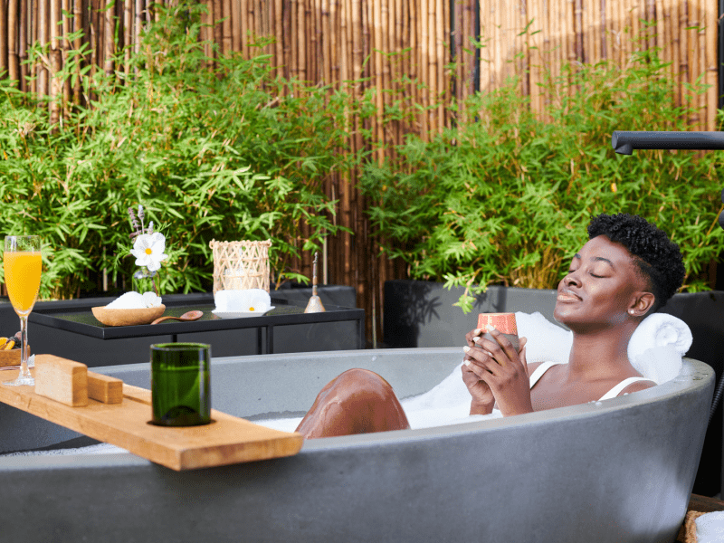 Person relaxing in an outdoor bathtub