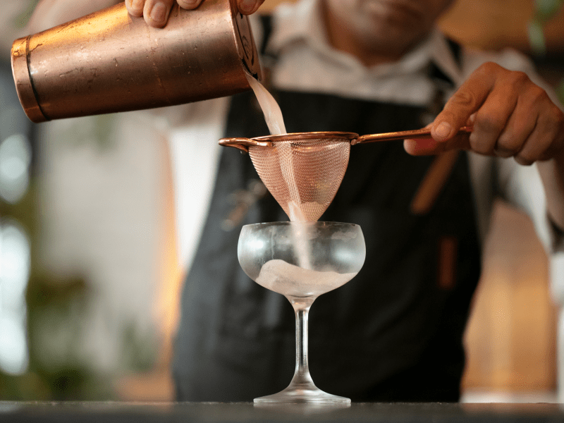 pouring and straining cocktail