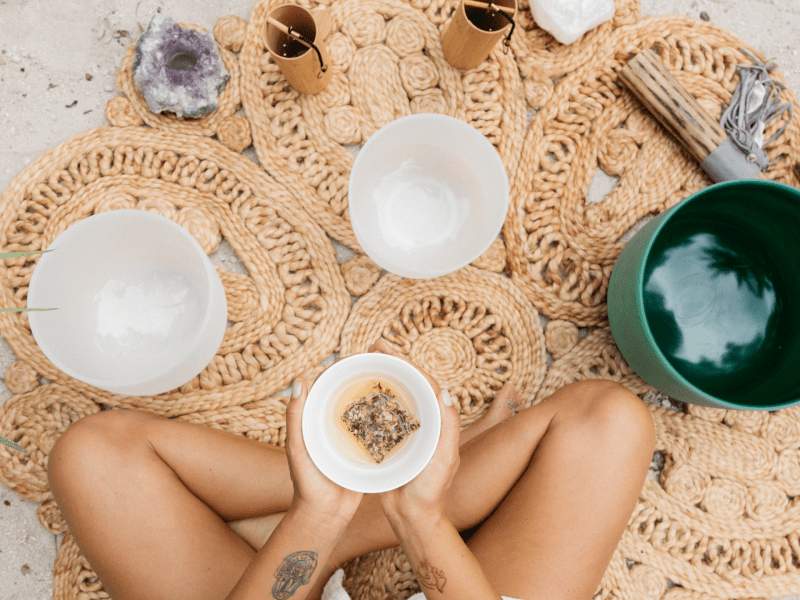 Woman holding a bowl performing a mindfulness ceremony
