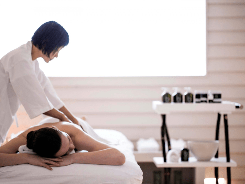 A person receiving treatment on a massage table 