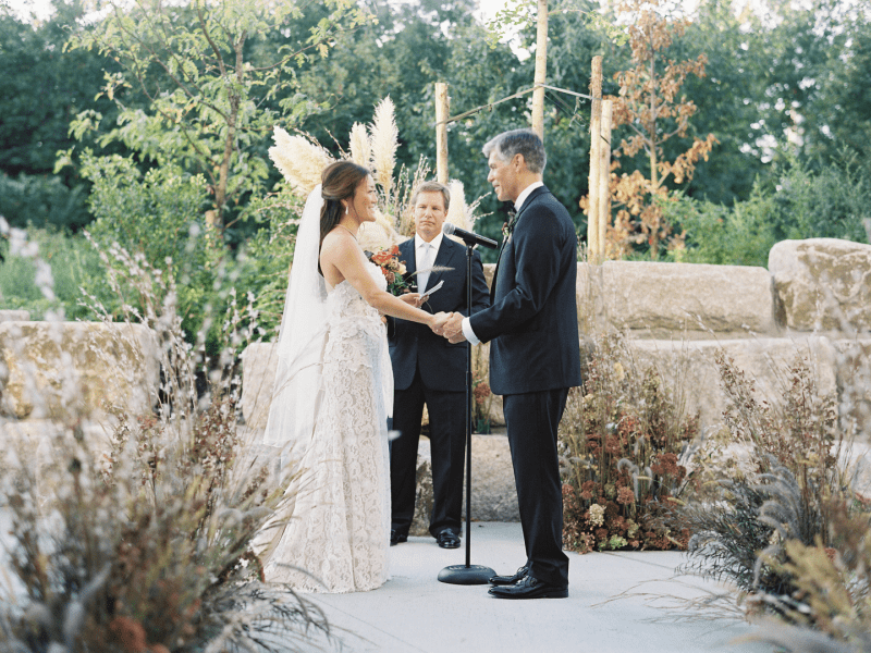 A couple standing together at a wedding ceremony