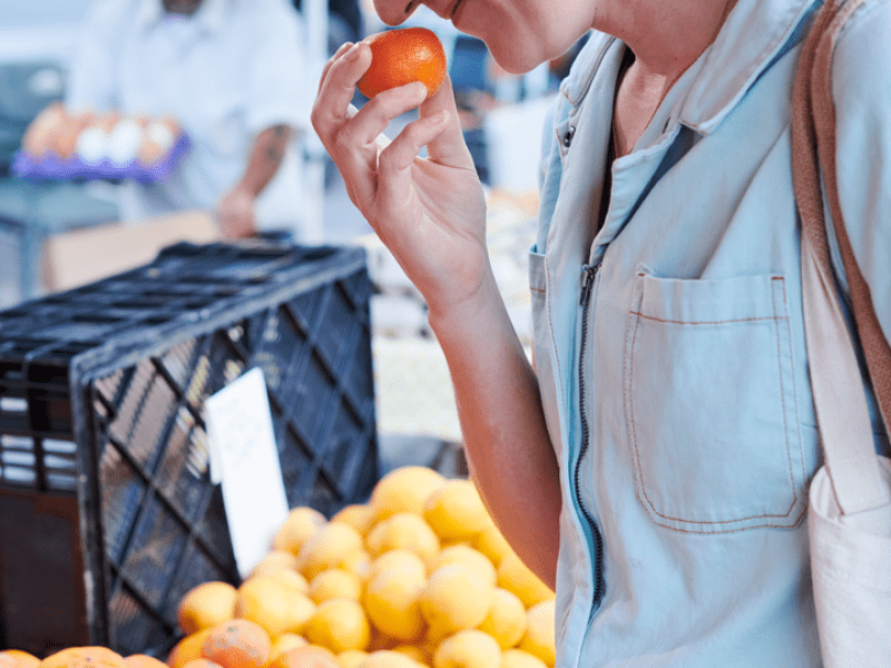 Person smelling a tangerine