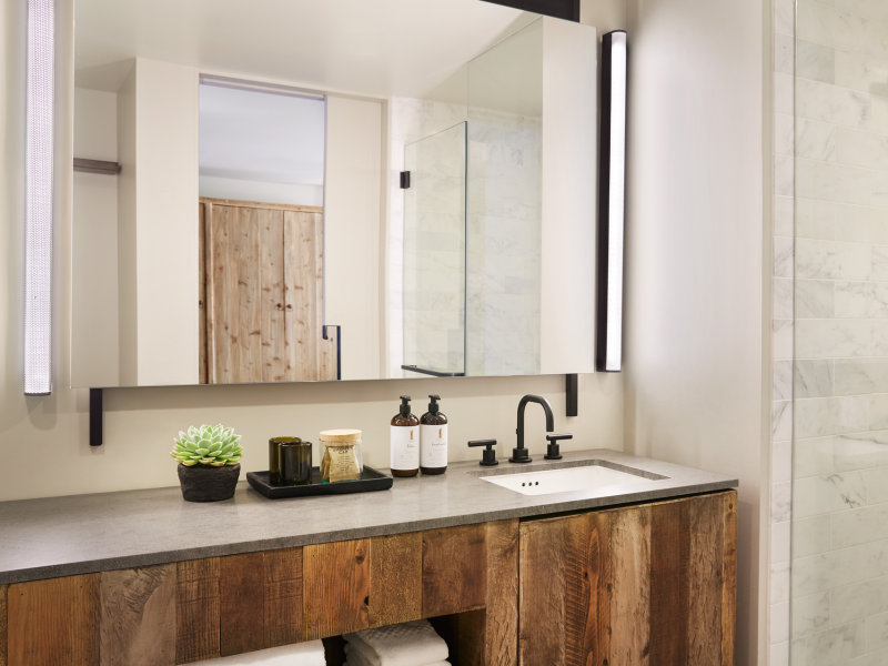 Ivory tiled bathroom with wooden vanity