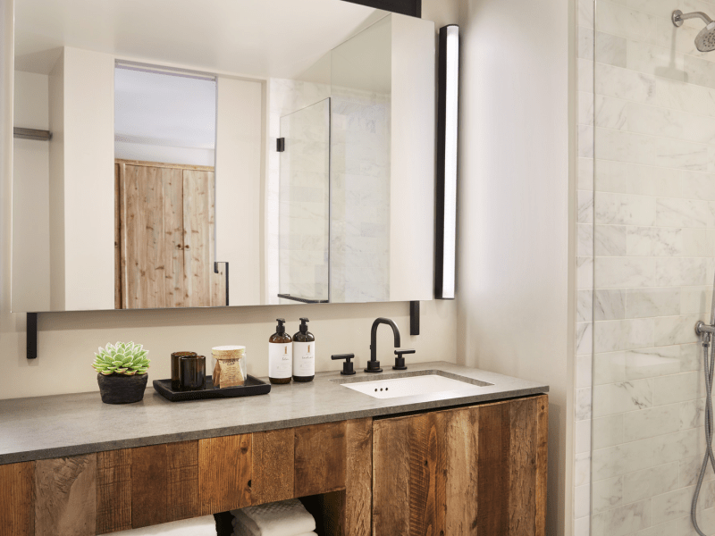 Ivory tiled bathroom with wooden vanity