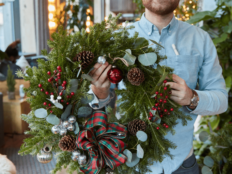 man holding wreath