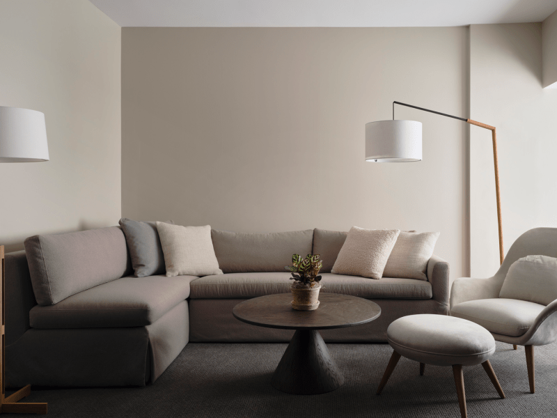 Dark themed living room area with sectional couch